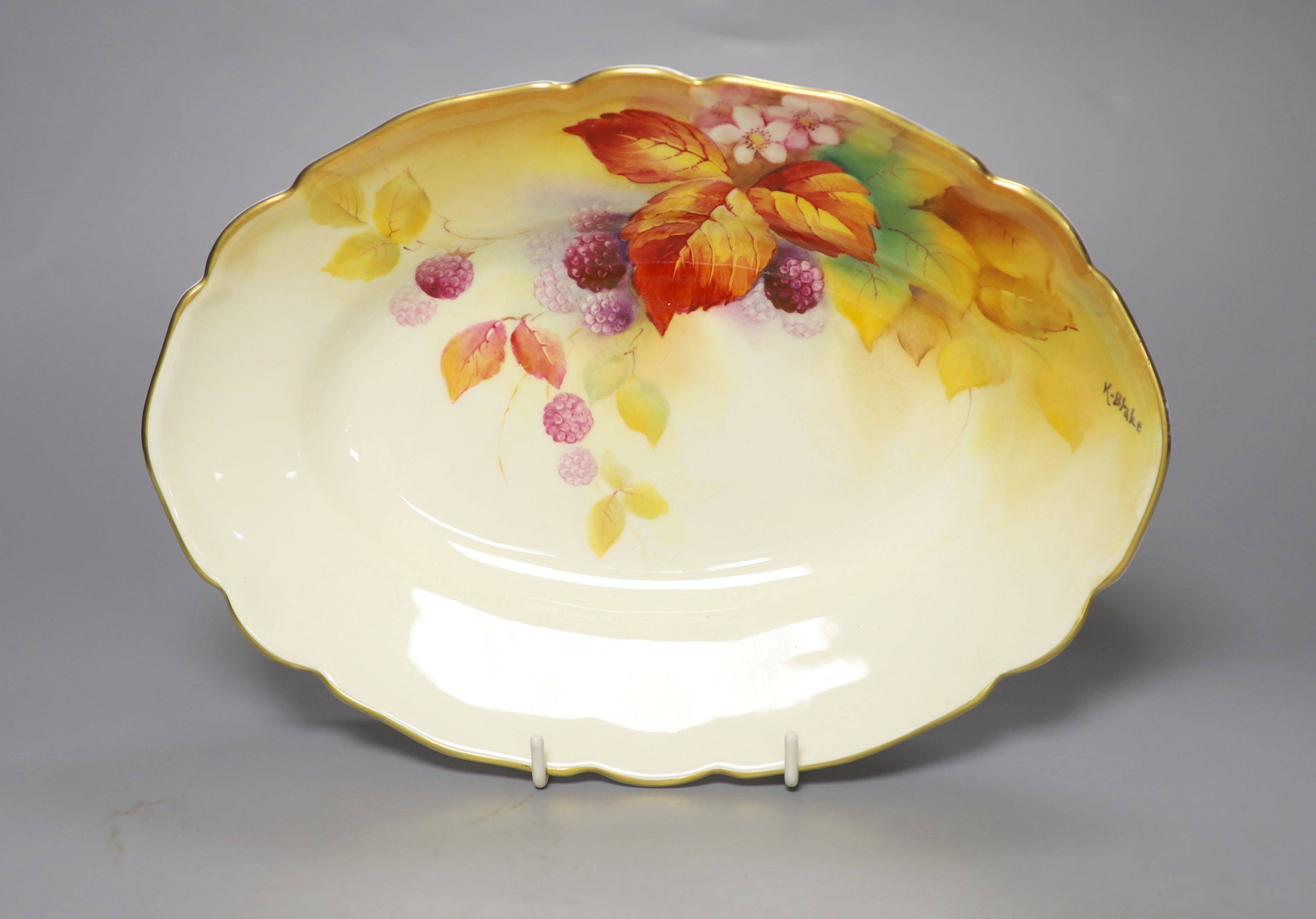 A Royal Worcester oval dish painted with autumnal leaves and berries by Kitty Blake, signed, date mark 1933